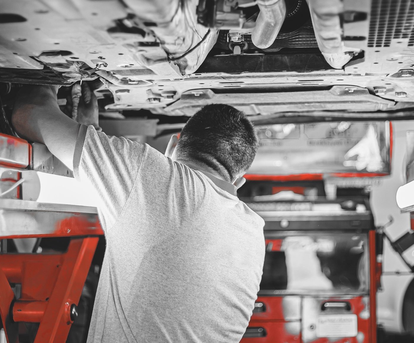 Mechanic working under a car on a lift
